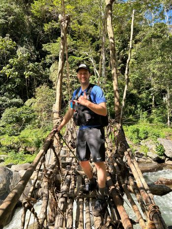 Ben standing on a bridge on the Kokoda Trail